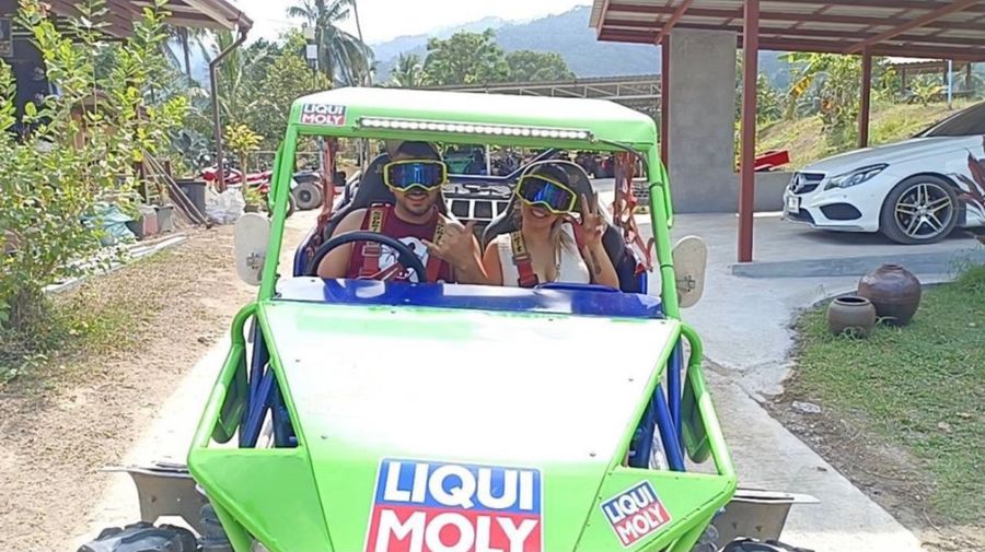 Two guests in a green buggy, ready to set off