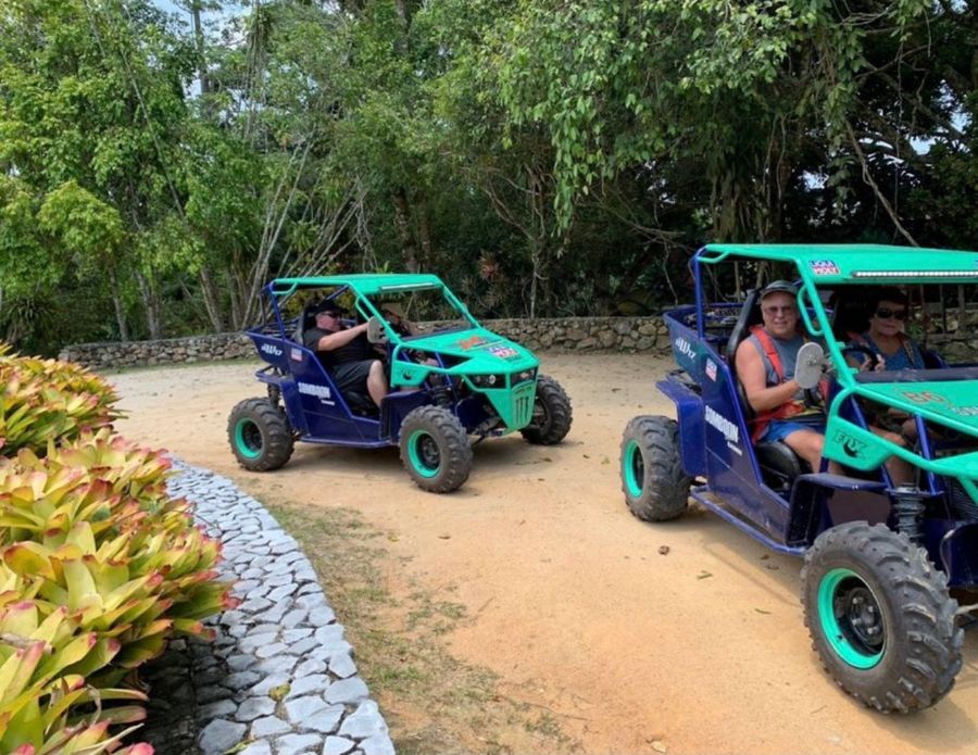 Buggies driving on a dirt track through the jungle