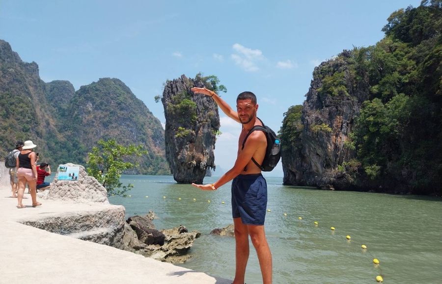 Guest posing with the James Bond Island rock behind him