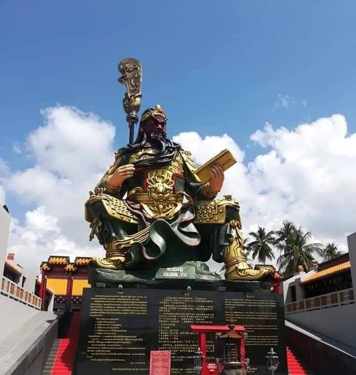 Large seated warrior statue at a temple
