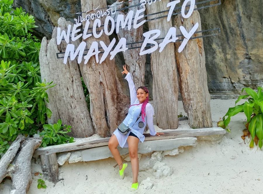 Guest posing under the Welcome to Maya Bay sign